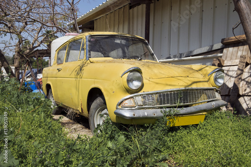 yellow old-timer car in green grass