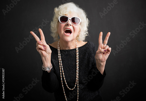 Cool grandmother showing peace sign