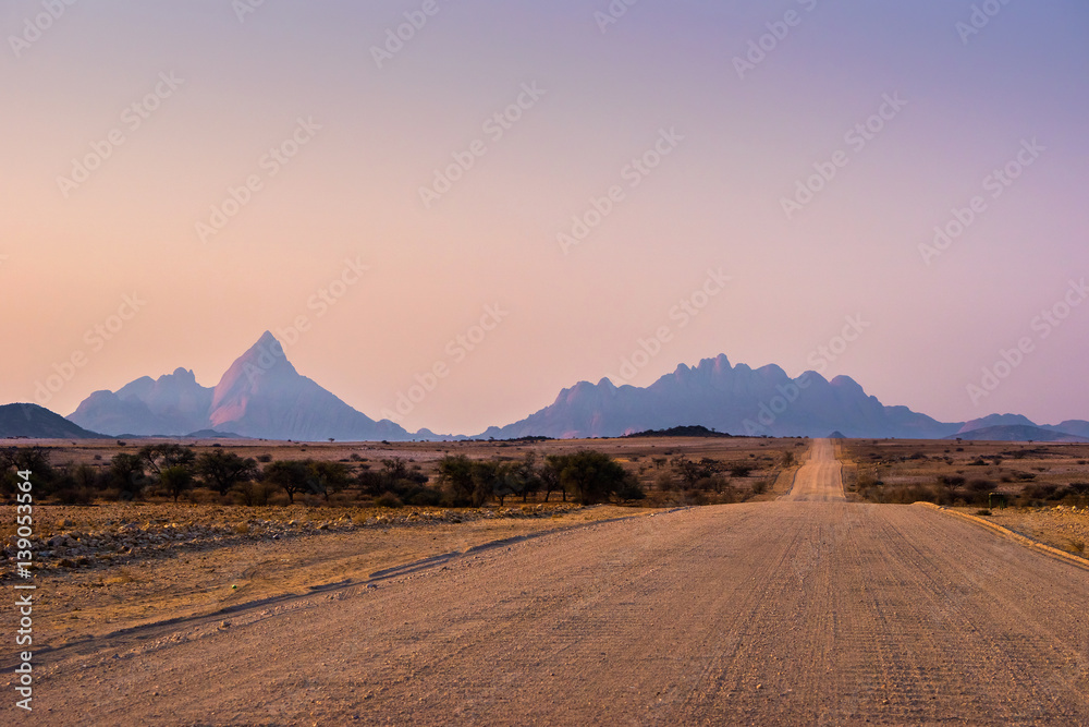 Gravel road to Mt. Spitzkoppe, Namibia, at sunset.