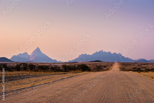 Gravel road to Mt. Spitzkoppe, Namibia, at sunset.