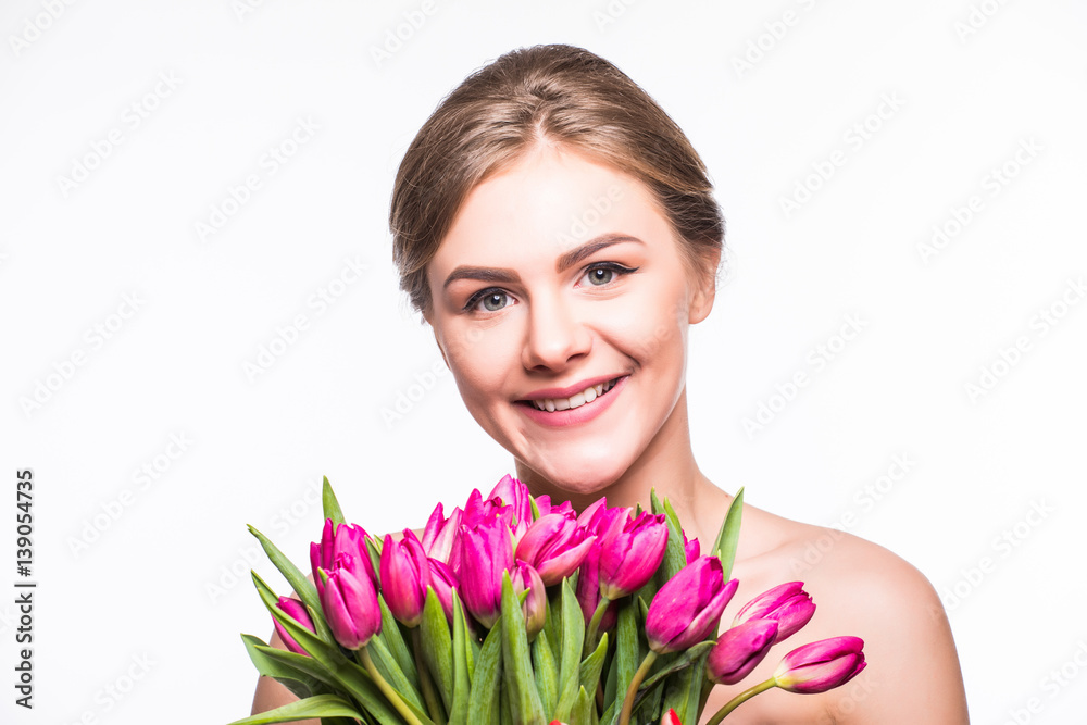 Beautiful girl with flowers tulips in hands on a light background Beautiful girl with flowers tulips in hands on a light background