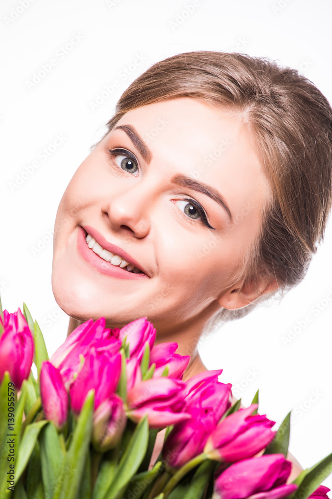 Close-up portrait of pretty woman with flowers near her face Close-up portrait of pretty woman with flowers near her face