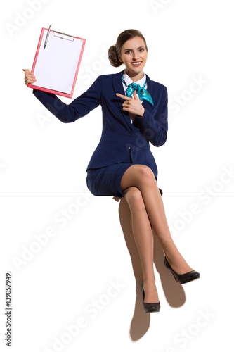 Businesswoman Sitting On A Top And Pointing At Clopboard photo