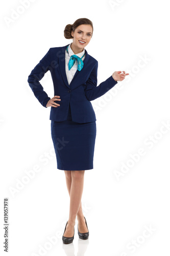 Smiling Stewardess Posing And Pointing