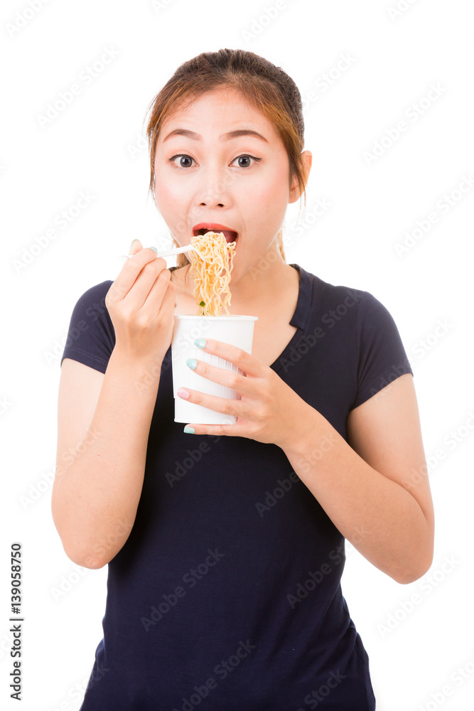 Young beautiful asian girl eating instant noodle using plastic fork. Young beautiful asian girl eating instant noodle using plastic fork.