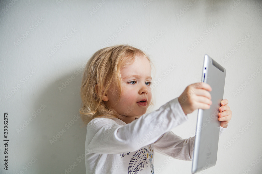 Pretty little girl with a Tablet PC. Isolated on white. Pretty little girl with a Tablet PC. Isolated on white.