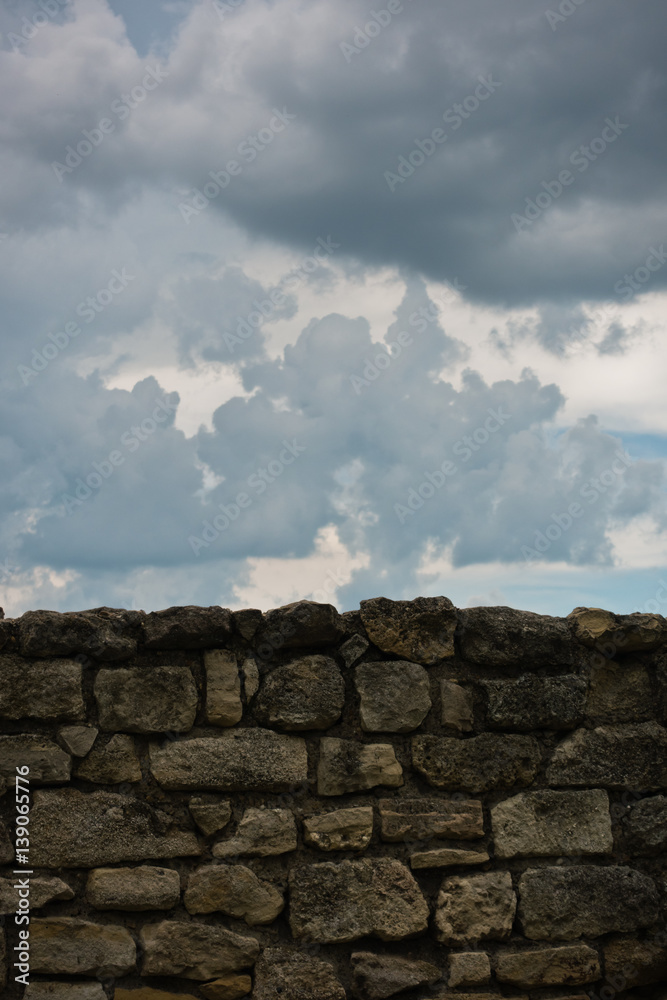 Old stone wall against dark clouds at Kalemegdan fortress in Belgrade, Serbia