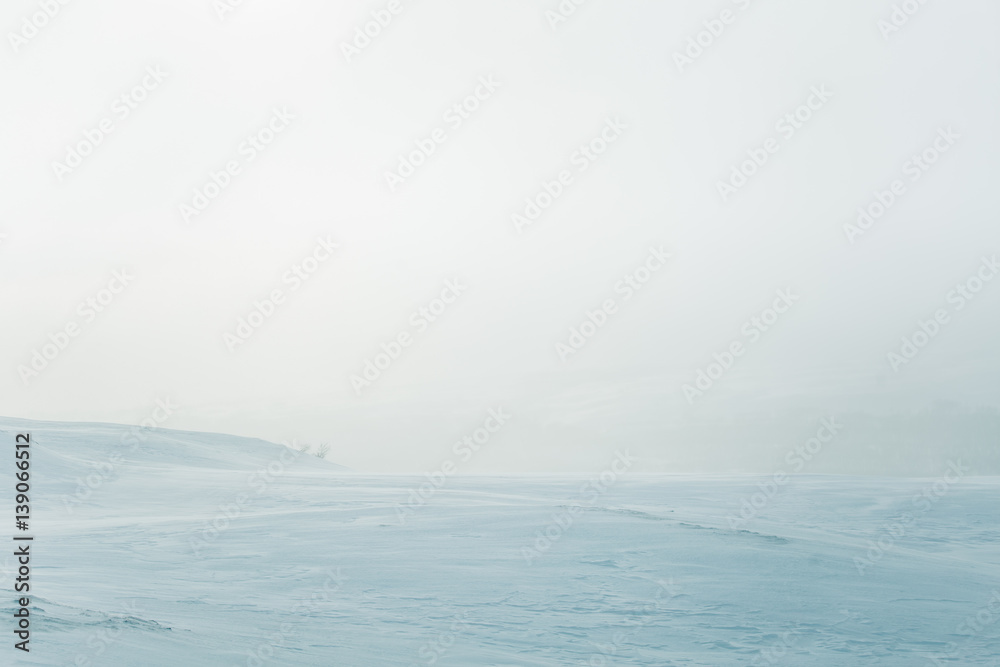 A beautiful, minimalist landscape of flat, snowy Norwegian field. Clean, light, high key, decorative look.