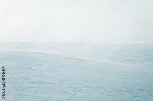 A beautiful, minimalist landscape of flat, snowy Norwegian field. Clean, light, high key, decorative look.