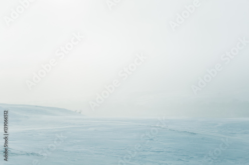 A beautiful, minimalist landscape of flat, snowy Norwegian field. Clean, light, high key, decorative look. © dachux21