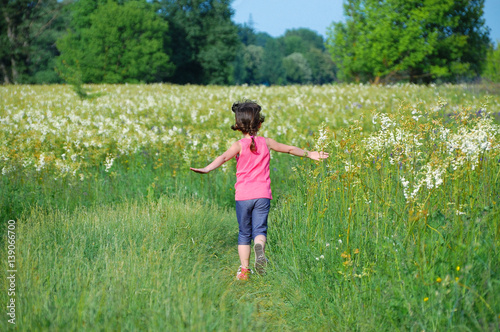 Child on green spring meadow  kid running and having fun outdoors  