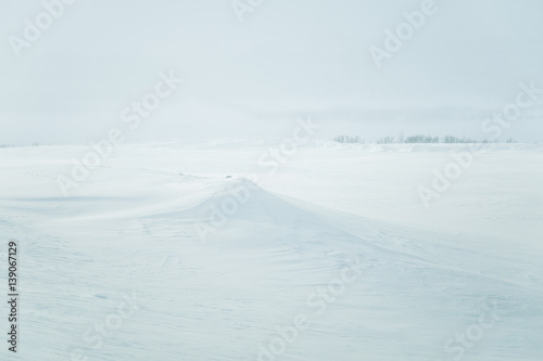 A beautiful, minimalist landscape of snowy Norwegian hills. Clean, light, high key, decorative look. © dachux21