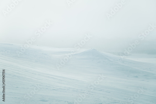 A beautiful, minimalist landscape of snowy Norwegian hills. Clean, light, high key, decorative look.