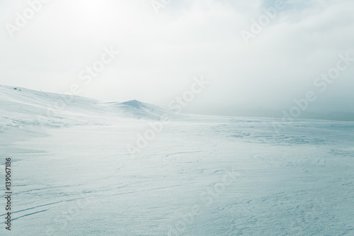 A beautiful, minimalist landscape of snowy Norwegian hills. Clean, light, high key, decorative look. © dachux21