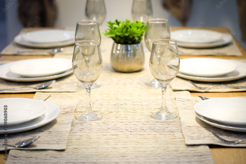 Plates and wine glasses on the table were empty. Plates and wine glasses on the table were empty.