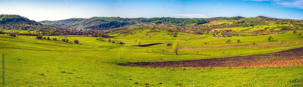 Fototapeta premium Farmland in spring colors. Valea Plopului village, Prahova county, Romania