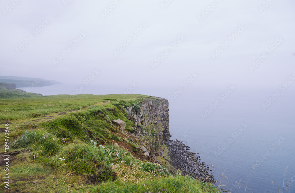 rock beach cliff edge on a foggy rainy weather, dark ocean rock beach cliff edge on a foggy rainy weather, dark ocean