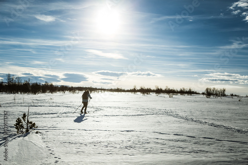 A girl skiing in a snowy Norwegian landscape. 