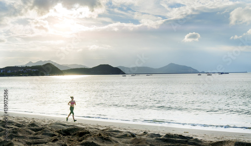 Sport woman running on the beach