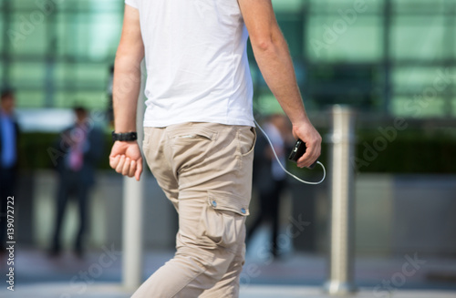 Man walking with the mobile phone in the hand. Modern life concept