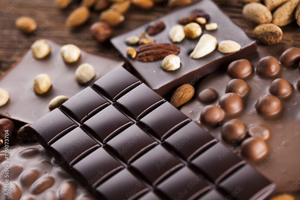 Fototapeta premium Dark homemade chocolate bars and cocoa pod on wooden