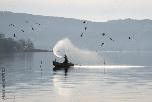 fisherman at lago Trasimeno Italy photo