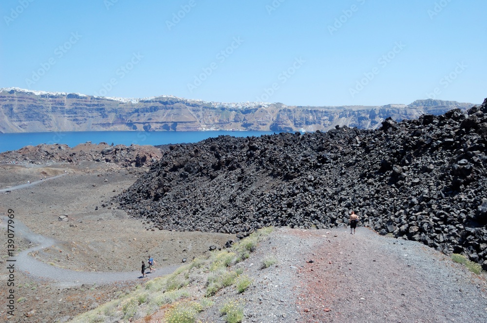 Coast of Santorini volcano, Greece. Caldera. Lifeless emissions of basalt, a reminder of the eruption. The view from the shore 