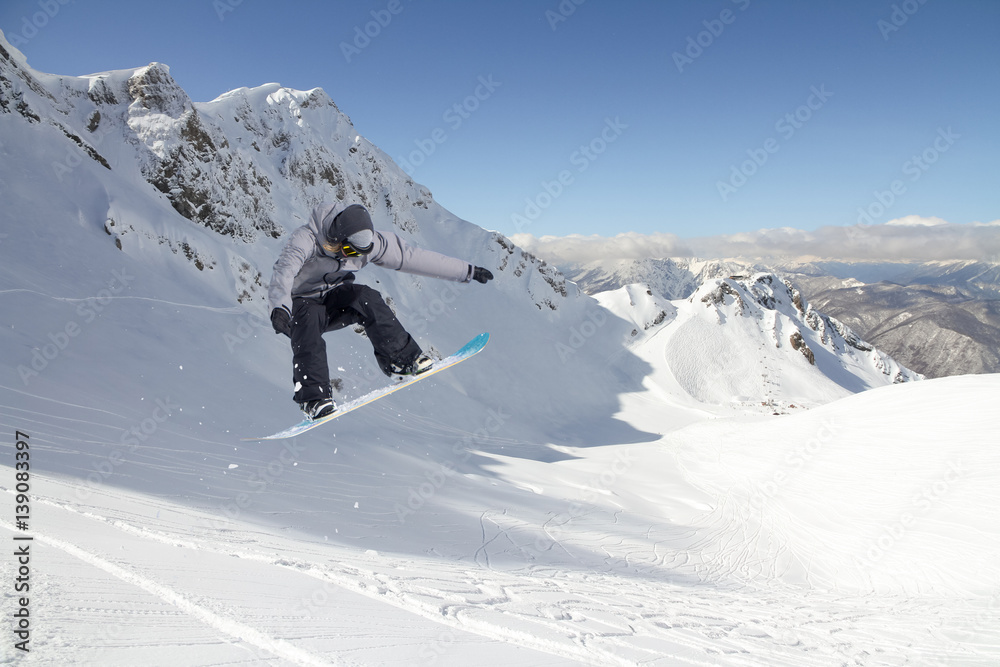 Jumping snowboarder in winter mountain. Extreme sport. Jumping snowboarder in winter mountain. Extreme sport.