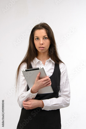 Attractive young business woman holding a digital tablet, on white