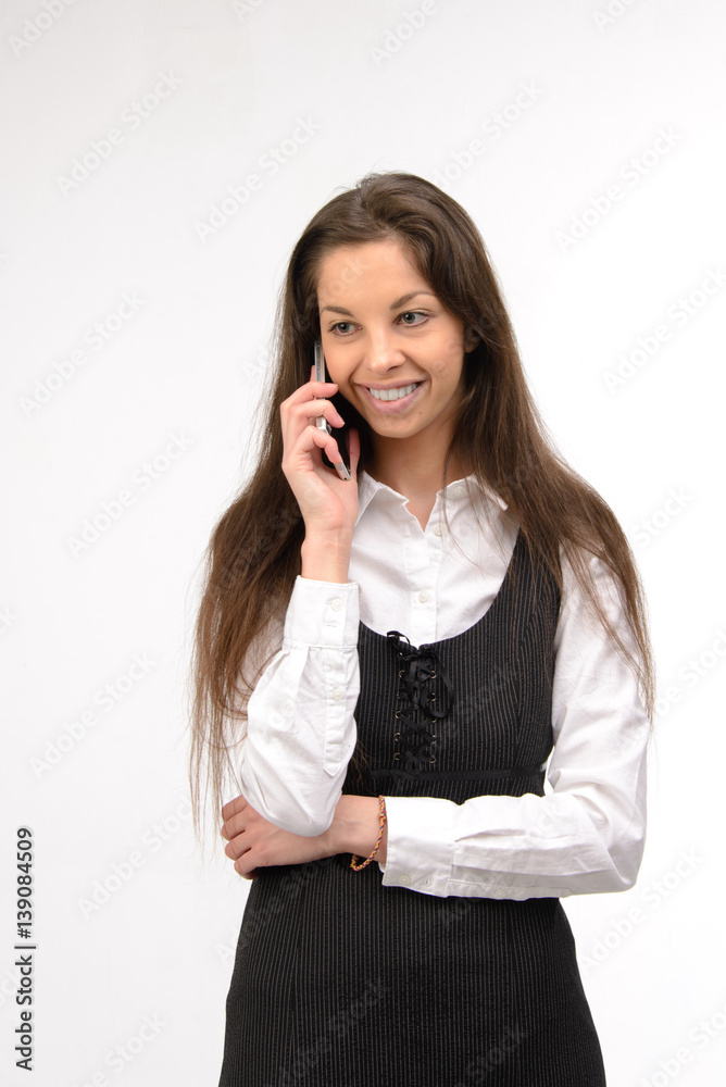 Attractive young business woman using her smartphone, on white Attractive young business woman using her smartphone, on white