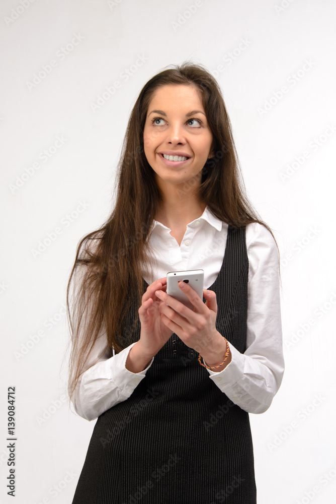Attractive young business woman using her smartphone, on white Attractive young business woman using her smartphone, on white