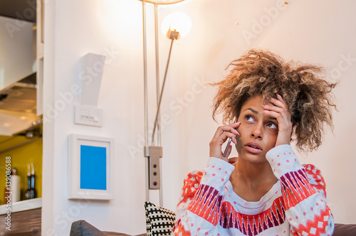 Nervous girl on mobile phone. Frowning young woman talking on telephone, something is wrong, problem. Young Woman Heard Bad News