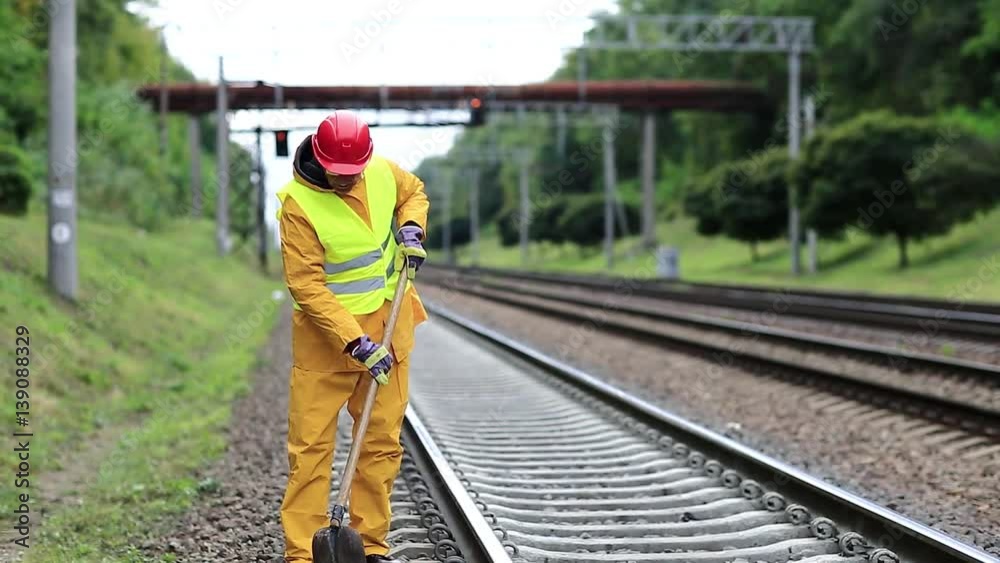 custom made wallpaper toronto digitalRepairman worker in yellow uniform with shovel in hands mends railway line. Railwayman in yellow uniform with shovel in hands repairs railway track. Workman with shovel on railway track