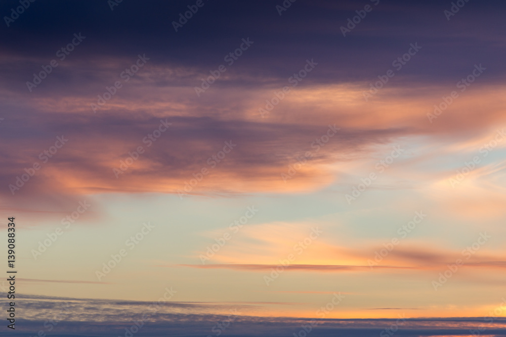 Beautiful cloudy sky background with sunset lights in violet tones Beautiful cloudy sky background with sunset lights in violet tones