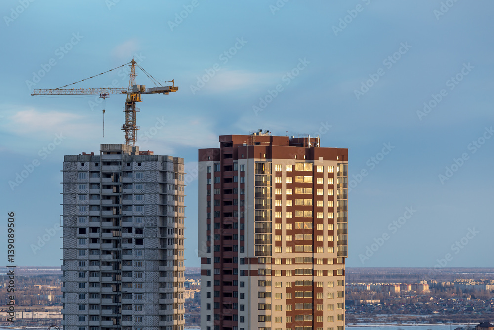 Construction of new modern skyscrapers at city Voronezh background with crane