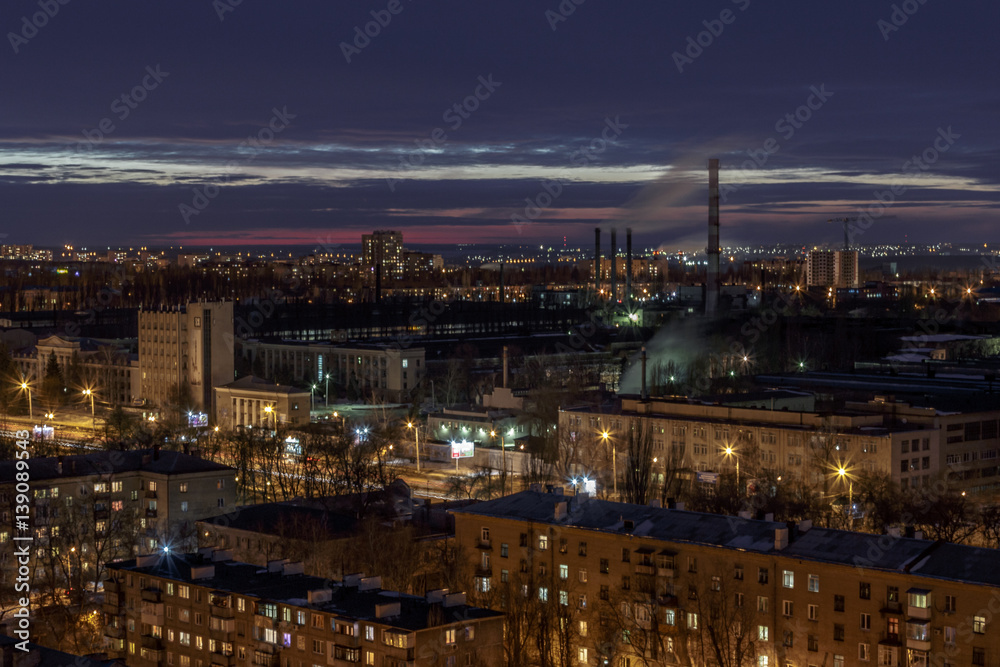 Night aerial winter cityscape view of industrial and living area in Voronezh