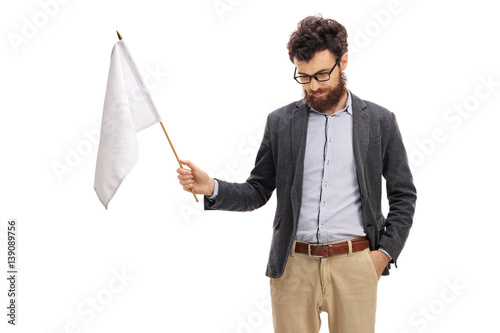 Man with his head down holding a white flag photo