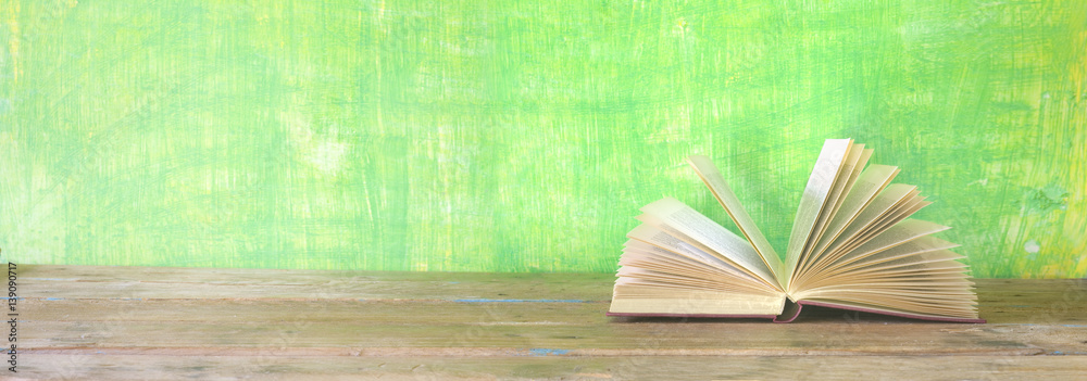 Obraz premium open book on green grungy background, good copy space