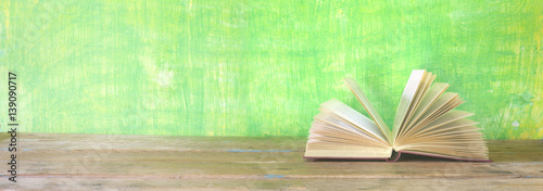 open book on green grungy background, good copy space