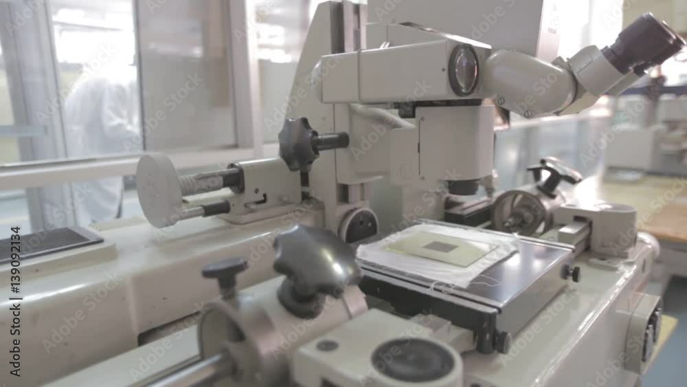Researchers working. Equipment for testing printed circuit boards on different defects. Microscope in a laboratory. Medicine manufacturing and lab equipment. Camera rise up Researchers working. Equipment for testing printed circuit boards on different defects. Microscope in a laboratory. Medicine manufacturing and lab equipment. Camera rise up