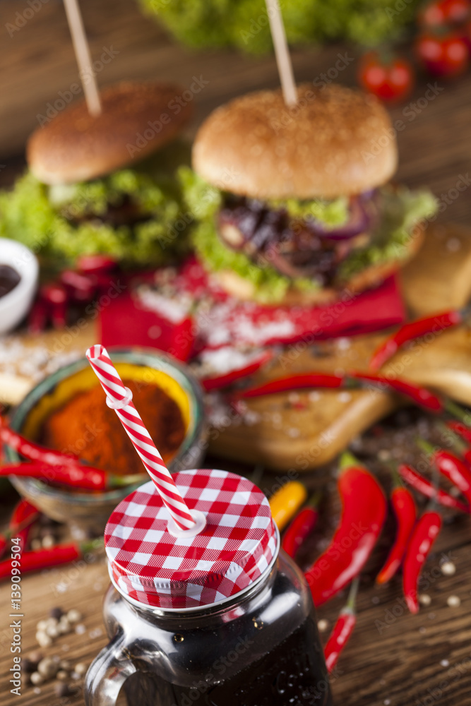 Home made burgers on wooden background