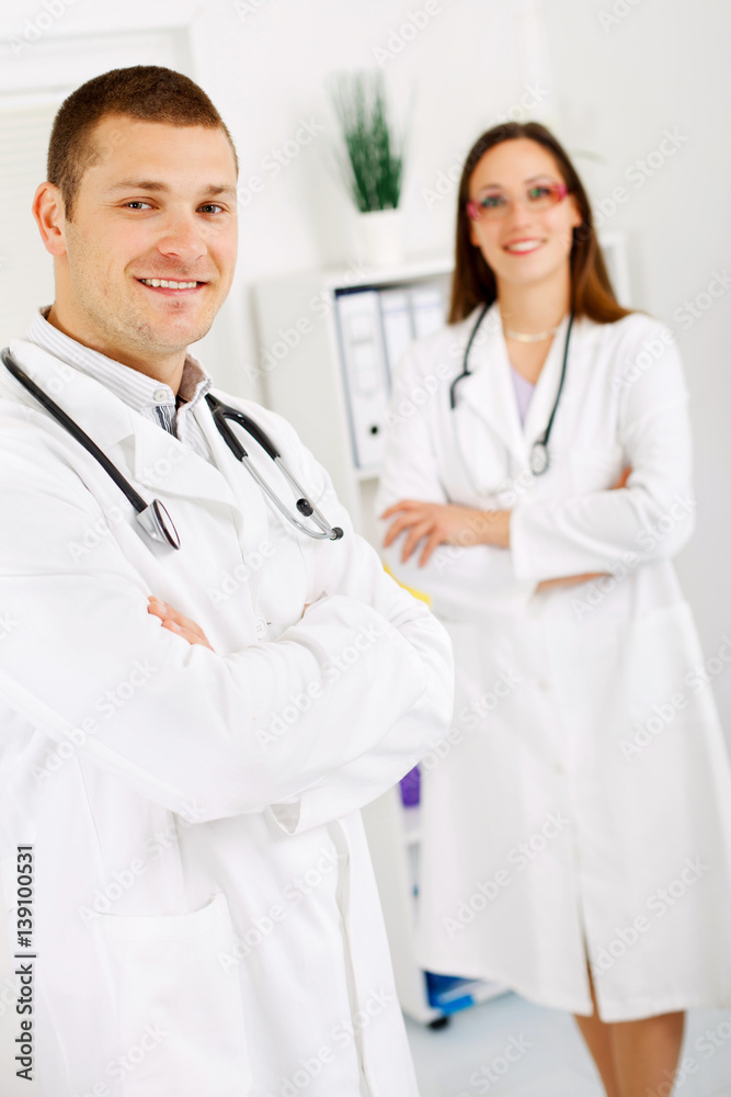 Two confident doctors standing at the office. Two confident doctors standing at the office.