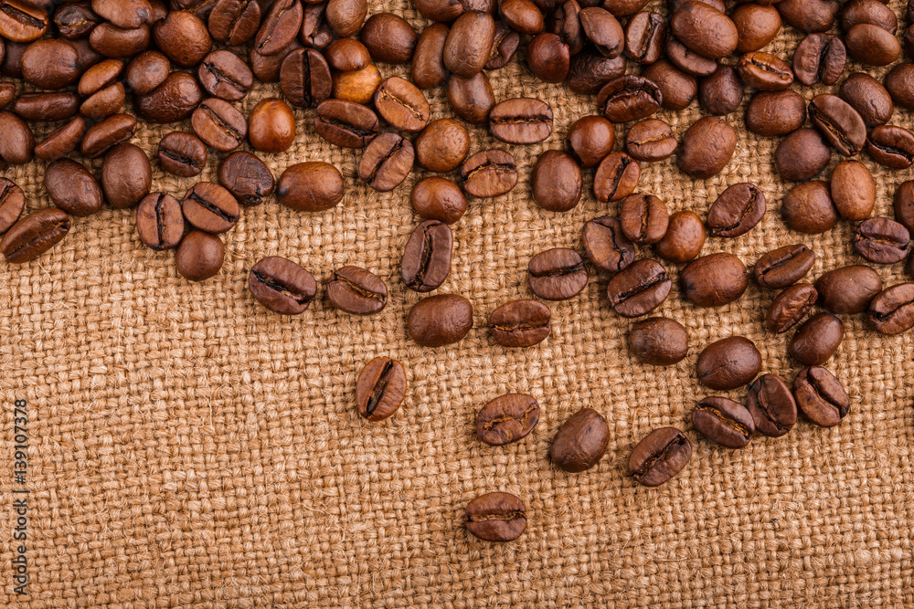 coffee beans on burlap background. roasted coffee beans isolated in white background. Roasted coffee beans background close up. Coffee beans pile from top on white background with copy space for text coffee beans on burlap background. roasted coffee beans isolated in white background. Roasted coffee beans background close up. Coffee beans pile from top on white background with copy space for text