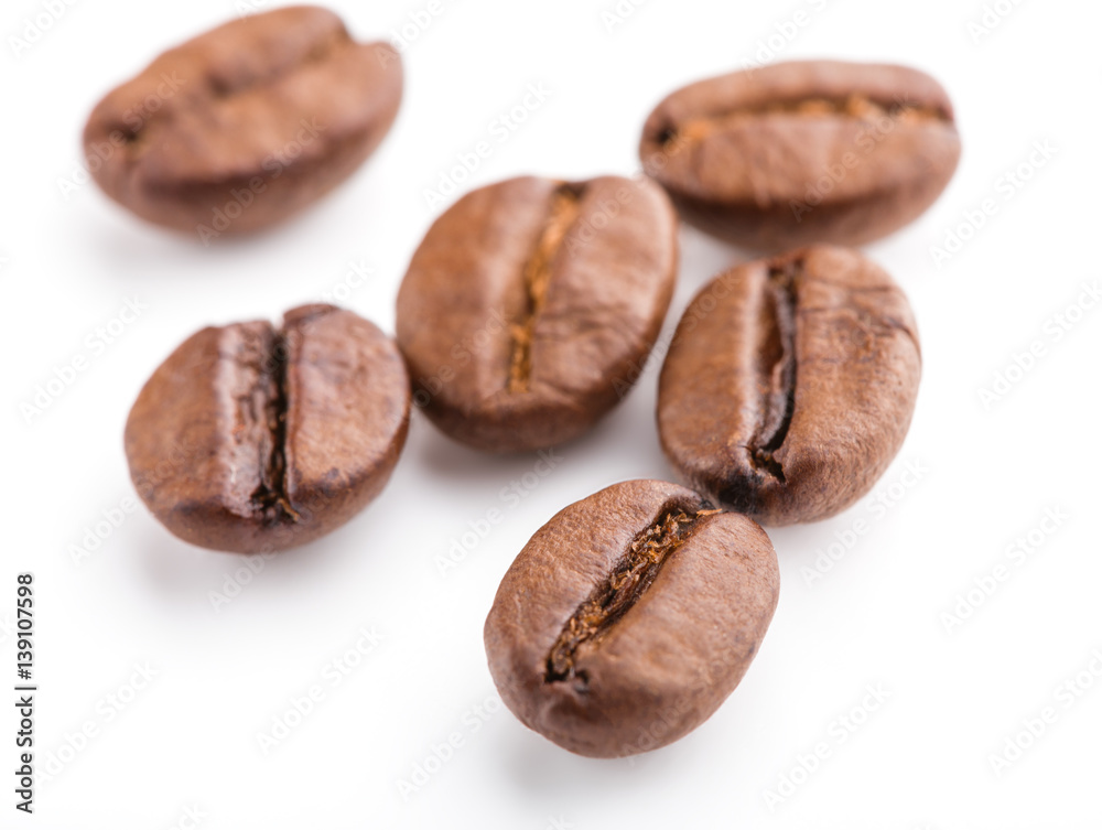 roasted coffee beans isolated in white background. Roasted coffee beans background close up. Coffee beans pile from top on white background with copy space for text. Good morning. roasted coffee beans isolated in white background. Roasted coffee beans background close up. Coffee beans pile from top on white background with copy space for text. Good morning.