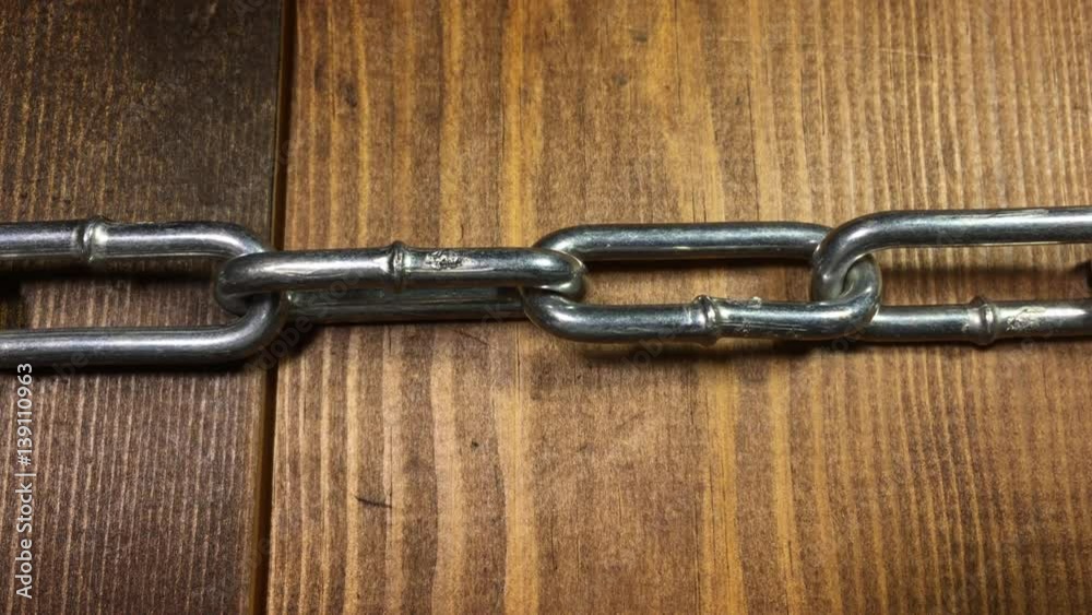 A steel chain pulled into tension and then moving to the left. Teamwork