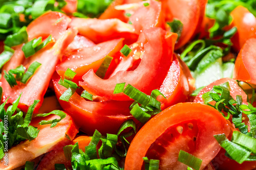 Background of tomato salad with green onions, black pepper and olive oil