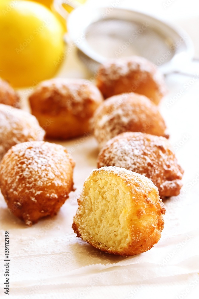Ricotta Donuts ( Fritters) dusted with powdered sugar on white background, selective focus