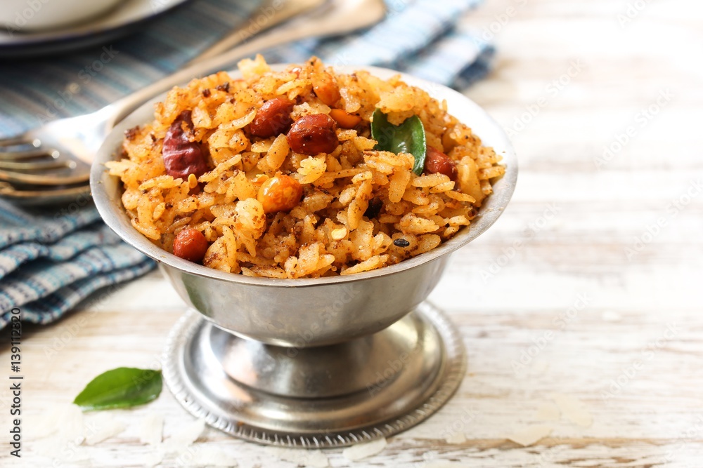Tamarind Poha / Puli Aval - South Indian breakfast with flattened rice, selective focus Tamarind Poha / Puli Aval - South Indian breakfast with flattened rice, selective focus