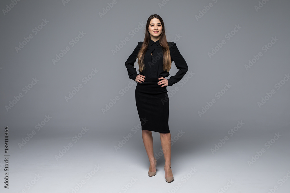 Portrait of a beautiful young business woman against grey background Portrait of a beautiful young business woman against grey background