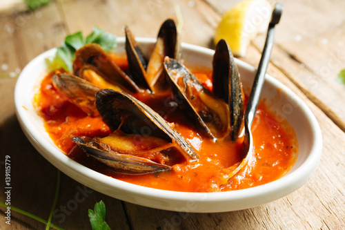 Mussel dish cooked in red marinara sauce 